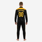Custom black and gold soccer tracksuit back view showing Athletic Gold yoke panel and back name number print on adult male model