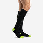 Custom black and green soccer socks left side view displaying over-the-calf length and ribbed elastic cuff