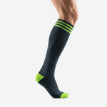 Custom black and green soccer socks left side view showing over the calf length and neon green heel panel