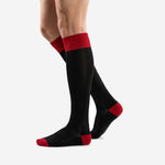 Custom knee high black and red soccer socks rear angle showing full calf length and ribbed top band