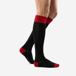 Custom black and red soccer socks showing ribbed cuff and jet black calf panel side angle view
