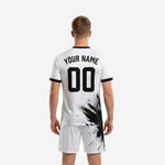 Detail view of custom black and white soccer uniform halftone print transitioning from jet black to white across the jersey chest