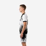 Custom black and white soccer uniform right-side view showing clean white jersey body and black ink burst on matching shorts