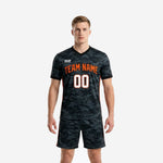 Men's custom black soccer kits with charcoal camo print and Blaze Orange side panels, front view