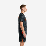 Custom black camo soccer kit side view showing Blaze Orange contrast panel on jersey and shorts