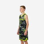 Side view of black and neon yellow-green sublimated youth basketball jersey and matching shorts showing armhole binding detail