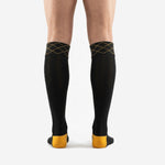 Close detail of custom black and gold soccer socks diamond geometric cuff band with Athletic Gold stitching on Jet Black base