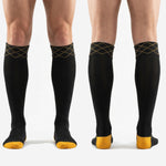 Full length profile of custom black and gold soccer socks showing knee high fit over shin guard position on adult male model