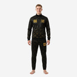 Custom black and gold soccer tracksuit front view, full zip jacket and tapered pants with gold ornamental sublimation print