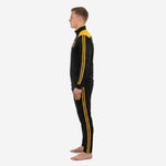 Custom black and gold soccer tracksuit tapered pants detail showing twin Athletic Gold stripes and ribbed ankle cuff on adult male model