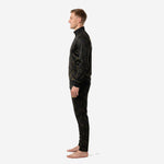 Custom black and gold soccer tracksuit right side view on adult male model, tapered pant leg and stand collar detail