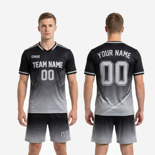 Custom black and gray soccer shorts showing white side stripe and gradient fade from black waistband to silver hem
