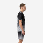 Custom black and gray soccer uniforms left side view showing white sleeve trim and gradient shorts stripe