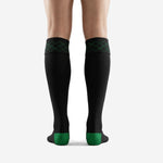 Close detail of black soccer socks cuff band with Kelly Green diamond argyle pattern on fold-over top