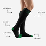 Heel detail of black and green soccer socks showing Kelly Green contrast heel cup and reinforced construction