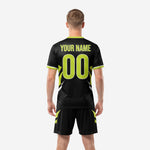 Close detail of neon green geometric ray pattern and team name print zone on custom all black soccer jersey