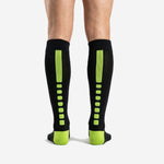 Custom black and neon green soccer socks calf panel detail showing ribbed knit structure and full-dye sublimation finish