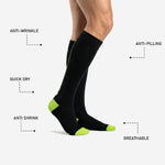 Custom black and green soccer socks close-up of neon green heel accent with reinforced construction for matchday wear