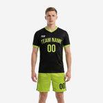 Custom black and green soccer uniforms front view showing neon green team name and number on jet black jersey with matching neon green shorts