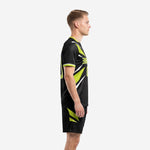Custom jet black and neon green soccer uniform set showing left side panel and sleeve trim detail on male model