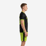 Custom black and neon green soccer uniform left side view showing breathable mesh side panels and neon green shorts with black stripe