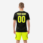 Custom black soccer jersey back detail with neon yellow player name arcing above back number in concentric-circle graphic design