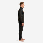 Custom black and orange soccer tracksuit left side view showing chevron geometric pattern across jacket sleeve and tapered pant leg