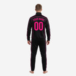 Custom black and pink soccer tracksuit jacket close-up showing sublimated hot pink stripe trim on raglan seams and full-zip collar
