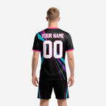 Custom black and pink soccer jersey detail showing hot pink crew neck trim and ray-burst chest print with team name and number