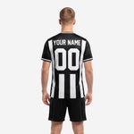 Detail view of custom black and white pinstripe soccer jersey with sublimated team name