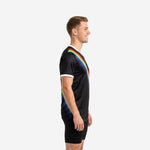 Custom black soccer training jersey showing rainbow sublimation stripe from shoulder to hem, left side view