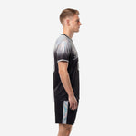 Men's custom black and silver gradient soccer uniform side view showing sleeve trim and shorts side stripe