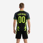 Detail view of custom black soccer jersey with neon green team name, number, and lightning bolt side panel sublimation print