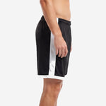 Custom black soccer shorts showing full-length white contrast side panel on left leg, side profile view on male model