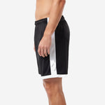 Custom black soccer shorts with white side panel and white hem band visible from right side profile on male model