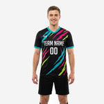 Custom black soccer training jersey with turquoise hot pink and neon yellow slash graphic front view on adult male model