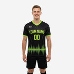 Custom black soccer training jersey with lime green soundwave graphic and V-neck collar, front view on male model