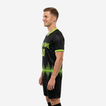 Mens custom soccer training jersey in black and lime green, right side view showing lower hem graphic