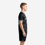Custom black soccer uniforms constellation kit shown from left side, powder blue trim on collar and sleeve cuffs visible