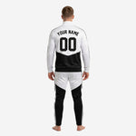 Back view of custom black and white soccer tracksuit with YOUR NAME and 00 player number sublimated on white jacket panel above black colorblock