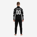 Custom black and white soccer tracksuit jacket closeup showing sublimated brushstroke pattern on sleeve