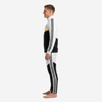 Mens black and white soccer tracksuit side view displaying Athletic Gold chest band, stand collar full zip, and tapered black and white pants