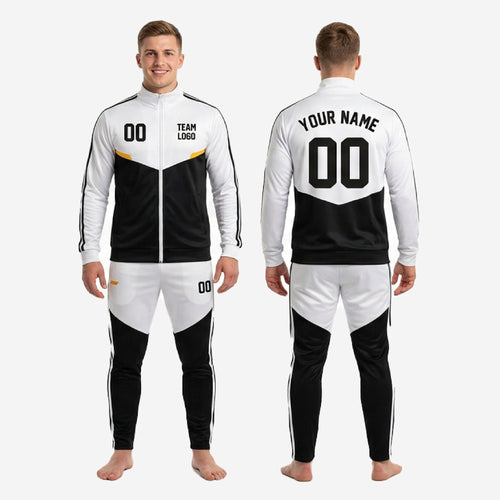 Black and white custom soccer tracksuit tapered pants detail showing white thigh panel, black lower leg, and three-stripe side stripe