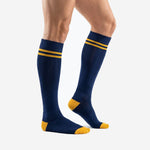 Custom blue and gold soccer socks showing Navy Blue body with Athletic Gold heel cap and double stripe, side view