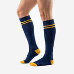 Custom blue and gold soccer socks with Athletic Gold toe cap and double calf bands, three-quarter angle view