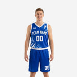 Custom blue basketball uniforms in royal blue and white with geometric shard burst pattern on jersey and shorts, front view full set