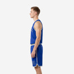 Side view of custom blue basketball uniforms showing royal blue jersey and shorts with silver-grey waistband and hem band on male model