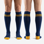 Custom blue and gold knee-high soccer socks with team name and number placement zones, full-length view