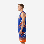 Side view of royal blue and orange custom basketball uniform showing orange armhole binding, slash pattern on jersey and shorts, and drawcord waistband