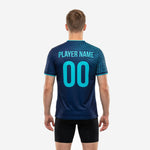 Close detail of teal geometric grid print on custom blue soccer training jersey shoulders and sleeves